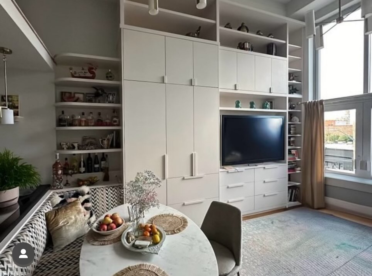 Finished floor-to-ceiling millwork wall with TV, pantry and drawers in a loft