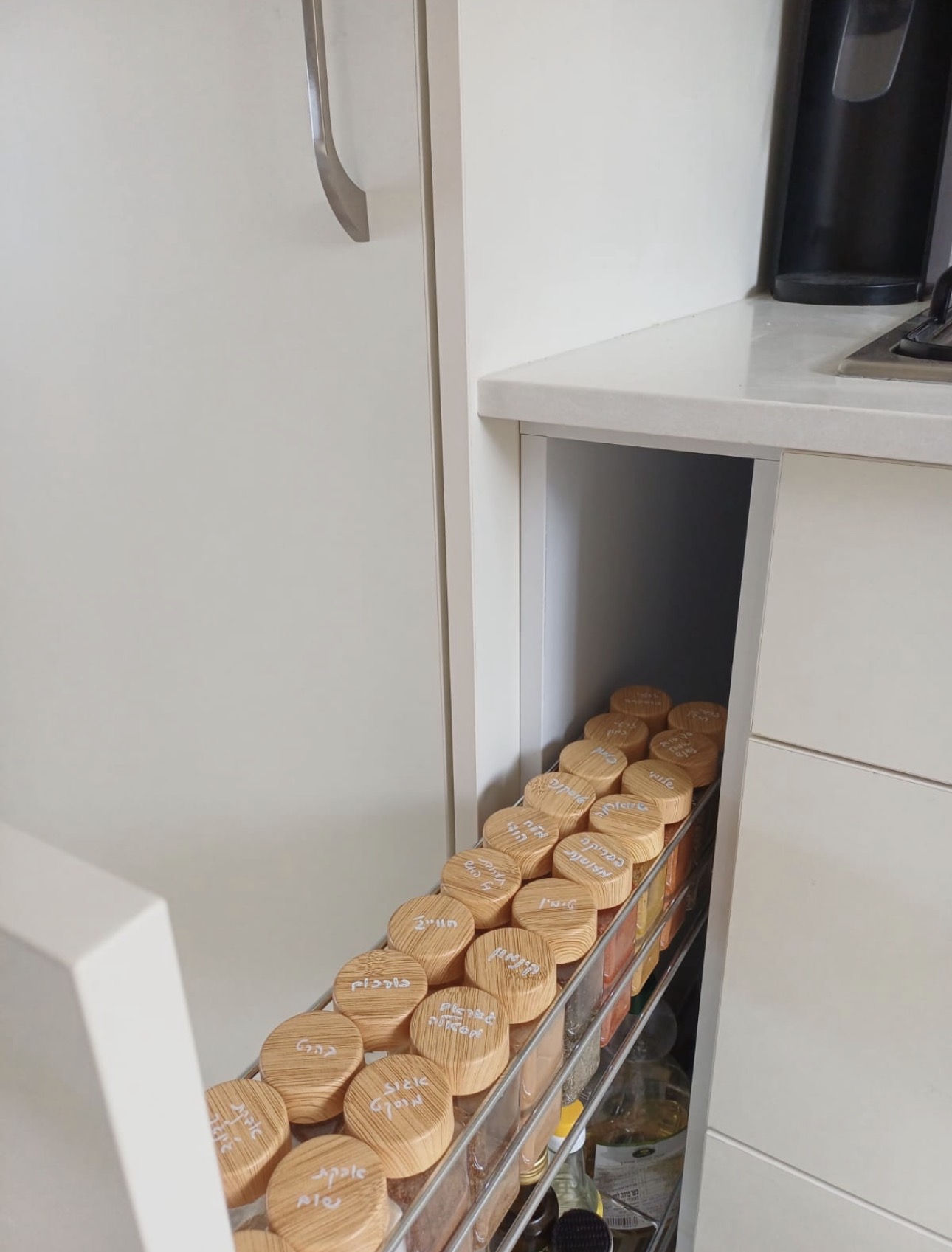 New kitchen — pull-out spice rack with hand-labeled wooden lids